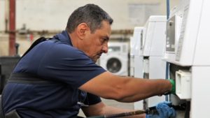 Technician repairing washing machine